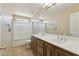 Bathroom vanity with double sinks and a tub with shower at 12748 N 57Th Dr, Glendale, AZ 85304