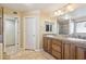 Bathroom featuring double sinks with granite countertop, and private door to the toilet/shower at 12748 N 57Th Dr, Glendale, AZ 85304