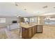 Open kitchen with an island, stainless steel dishwasher, and ample counter space at 12748 N 57Th Dr, Glendale, AZ 85304