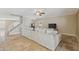 A cozy living room features a sectional couch, tile flooring and adjacent staircase at 12748 N 57Th Dr, Glendale, AZ 85304