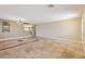 Spacious living room with stone tile flooring and staircase to the upper level at 12748 N 57Th Dr, Glendale, AZ 85304