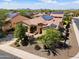 Aerial view of a home with solar panels, a tile roof, and desert landscaping at 12904 W Dale Ln, Peoria, AZ 85383