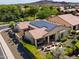 Stunning aerial view of the home highlighting the solar panels, covered patio, and meticulously maintained landscaping at 12904 W Dale Ln, Peoria, AZ 85383