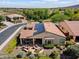 Beautiful aerial view of the backyard with a patio, solar panels, and lush landscaping at 12904 W Dale Ln, Peoria, AZ 85383