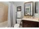 Inviting bathroom with a shower/tub combo, stylish vanity, and decorative mirror with flattering light at 12904 W Dale Ln, Peoria, AZ 85383