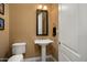 Stylish half bathroom featuring a pedestal sink, decorative mirror, and a well-placed towel rack at 12904 W Dale Ln, Peoria, AZ 85383