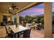 Spacious covered patio with a dining table and lounge chairs, ideal for enjoying outdoor meals and stunning sunset views at 12904 W Dale Ln, Peoria, AZ 85383