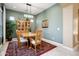 Cozy dining room featuring a round table, elegant rug, and a stylish china cabinet at 12904 W Dale Ln, Peoria, AZ 85383