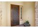 Elegant front door with decorative glass, flanked by brick accents, and a tiled porch at 12904 W Dale Ln, Peoria, AZ 85383