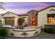 Charming home with a brick accent wall, a cozy front patio, and a two-car garage at 12904 W Dale Ln, Peoria, AZ 85383