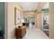 Inviting hallway with tiled floors leading to a dining area and comfortable living space at 12904 W Dale Ln, Peoria, AZ 85383