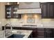 Close up on backsplash behind the stove, with granite countertops and custom cabinets at 12904 W Dale Ln, Peoria, AZ 85383