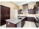 Spacious kitchen featuring an island, granite countertops, and modern stainless steel appliances at 12904 W Dale Ln, Peoria, AZ 85383