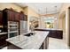Bright kitchen featuring stainless steel appliances, a large granite island, and custom cabinets at 12904 W Dale Ln, Peoria, AZ 85383