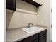 Well-maintained laundry room featuring a utility sink with a countertop at 12904 W Dale Ln, Peoria, AZ 85383