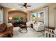Inviting living room with a ceiling fan, cozy seating, and natural light at 12904 W Dale Ln, Peoria, AZ 85383