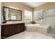 Relaxing bathroom with a soaking tub, walk-in shower, and spacious vanity at 12904 W Dale Ln, Peoria, AZ 85383
