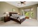 Serene bedroom with a ceiling fan and bright natural light from the large windows at 12904 W Dale Ln, Peoria, AZ 85383
