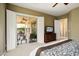 Comfortable bedroom with access to an outdoor patio and a TV at 12904 W Dale Ln, Peoria, AZ 85383