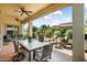 Covered patio with seating for outdoor dining and a lush garden view at 12904 W Dale Ln, Peoria, AZ 85383