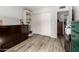Bedroom featuring a murphy bed, built in shelves, and wood-look flooring at 1401 E Puget Ave # 4, Phoenix, AZ 85020