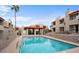 Inviting community pool surrounded by well-maintained condos with a covered seating area and ample space at 1401 E Puget Ave # 4, Phoenix, AZ 85020