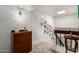 Bright hallway featuring a wooden dresser, and a collection of framed photos along the wall at 1401 E Puget Ave # 4, Phoenix, AZ 85020