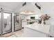 Bright, open kitchen featuring modern appliances, white cabinetry, and access to the outdoor patio at 1401 E Puget Ave # 4, Phoenix, AZ 85020