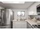 Updated kitchen featuring stainless steel appliances, white cabinetry, and quartz countertops at 1401 E Puget Ave # 4, Phoenix, AZ 85020