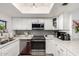 Modern kitchen with stainless steel appliances, white cabinetry, and a stylish backsplash at 1401 E Puget Ave # 4, Phoenix, AZ 85020