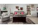 Bright living room featuring modern furniture, decorative floral wall art, and a built-in bookcase at 1401 E Puget Ave # 4, Phoenix, AZ 85020
