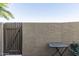 Private outdoor patio with a gate, table, and stucco walls, offering a cozy retreat at 1401 E Puget Ave # 4, Phoenix, AZ 85020