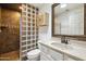 Bathroom with a unique glass block wall, shower, white vanity and toilet at 14910 N Kings Way # 206, Fountain Hills, AZ 85268