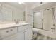 Bathroom with neutral walls, a white vanity, decorative mirror, and shower with glass doors at 14910 N Kings Way # 206, Fountain Hills, AZ 85268