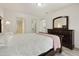 A clean bedroom featuring white walls, decorative furniture, and views of the bathroom and closet at 14910 N Kings Way # 206, Fountain Hills, AZ 85268