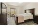 Bedroom featuring neutral walls, a decorative mirror, furniture, and access to a covered balcony at 14910 N Kings Way # 206, Fountain Hills, AZ 85268