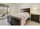 Bedroom with neutral walls, a decorative mirror, furniture, and access to a covered balcony at 14910 N Kings Way # 206, Fountain Hills, AZ 85268