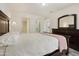 A clean bedroom featuring white walls, decorative furniture, and views of the bathroom and closet at 14910 N Kings Way # 206, Fountain Hills, AZ 85268