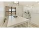 Well-lit kitchen and dining area featuring white cabinets, modern lighting, and a comfortable dining space at 14910 N Kings Way # 206, Fountain Hills, AZ 85268