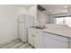 Bright kitchen featuring white appliances, white cabinets, and quartz countertops at 14910 N Kings Way # 206, Fountain Hills, AZ 85268