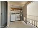 Enclosed laundry area featuring appliances, shelving, and water heater at 14910 N Kings Way # 206, Fountain Hills, AZ 85268