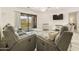 Well-lit living room with balcony access, with neutral-toned sofas and modern furnishings at 14910 N Kings Way # 206, Fountain Hills, AZ 85268