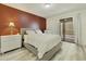 Cozy main bedroom with balcony access, featuring a rustic accent wall and modern furniture at 14910 N Kings Way # 206, Fountain Hills, AZ 85268