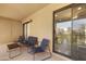 Balcony featuring cozy seating with serene views through sliding glass doors at 14910 N Kings Way # 206, Fountain Hills, AZ 85268