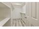 Walk-in closet with white shelves and neutral paint with wood look floor at 14910 N Kings Way # 206, Fountain Hills, AZ 85268