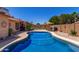 Serene backyard featuring a sparkling pool, a patio area, and lush greenery for ultimate relaxation and enjoyment at 15256 N 62Nd Ave, Glendale, AZ 85306