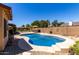 Inviting backyard with a sparkling pool, lush greenery, and a patio area for outdoor relaxation and entertainment at 15256 N 62Nd Ave, Glendale, AZ 85306