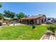 Lush backyard with a sparkling pool, a covered patio, and ample green space perfect for outdoor living and entertaining at 15256 N 62Nd Ave, Glendale, AZ 85306