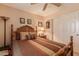 The bedroom includes a wooden-frame bed, ceiling fan, patterned bedspread, and decor at 15256 N 62Nd Ave, Glendale, AZ 85306