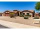Well-maintained single-story home featuring desert landscaping, a spacious driveway, and a welcoming entrance at 15256 N 62Nd Ave, Glendale, AZ 85306